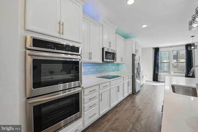9870 Buchanan Loop, Manassas, VA 20110 - kitchen featuring stainless steel appliances, a sink, white cabinets, tasteful backsplash, and recessed lighting