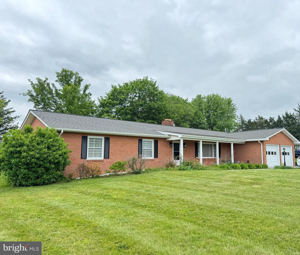 1793 N Hayfield Rd, Winchester, VA 22603 - single story home with a garage, brick siding, a front yard, and a chimney