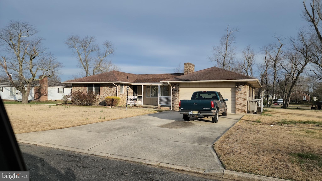 319 Morton Ave, Paulsboro, NJ 08066 - ranch-style home featuring a garage, a porch, a chimney, concrete driveway, and brick siding