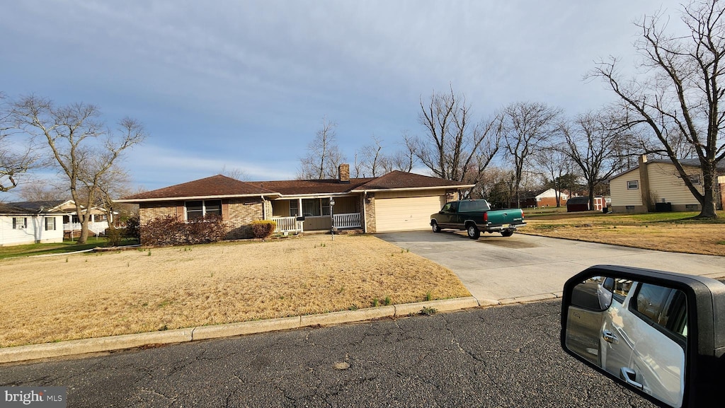 319 Morton Ave, Paulsboro, NJ 08066 - ranch-style home featuring driveway, a garage, a chimney, and brick siding