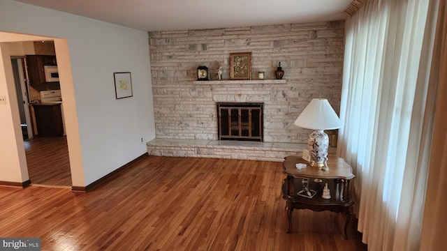 319 Morton Ave, Paulsboro, NJ 08066 - living area featuring a fireplace, wood finished floors, and baseboards