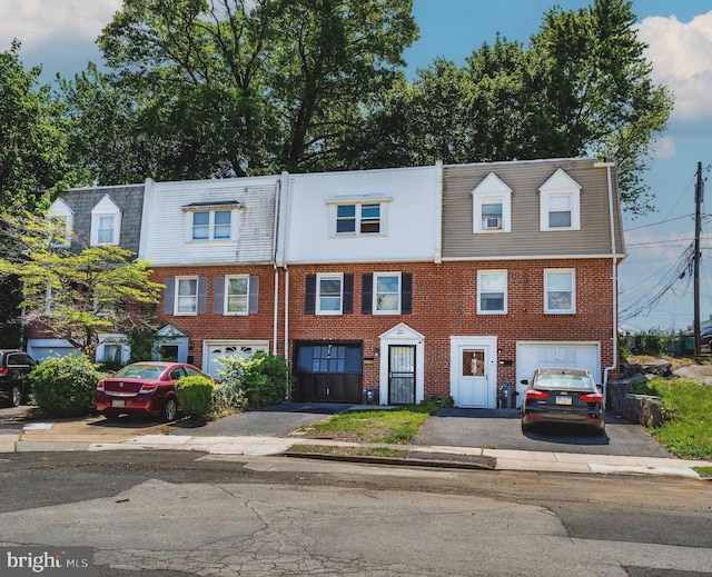 415 Arlington Ave, Upper Darby, PA 19082 - townhome / multi-family property with mansard roof, driveway, and a garage