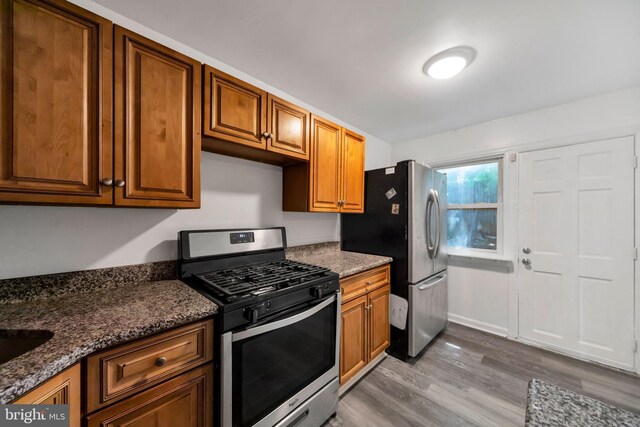 415 Arlington Ave, Upper Darby, PA 19082 - kitchen with appliances with stainless steel finishes, dark wood-style floors, and brown cabinetry