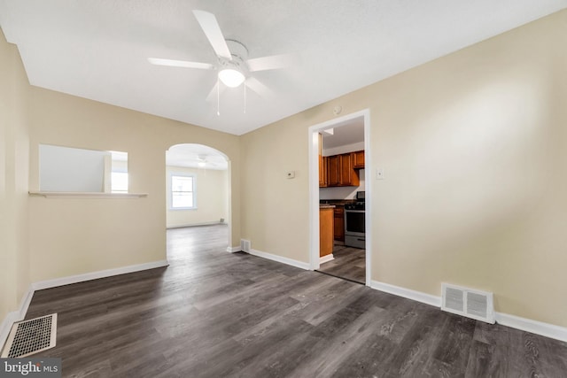 415 Arlington Ave, Upper Darby, PA 19082 - unfurnished room with a ceiling fan, arched walkways, dark wood-style floors, and baseboards