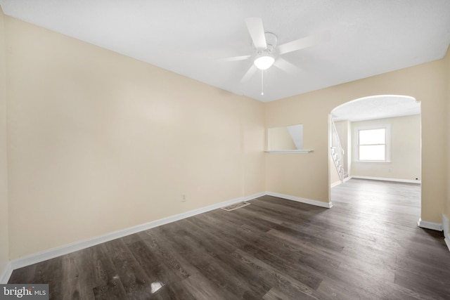 415 Arlington Ave, Upper Darby, PA 19082 - unfurnished room featuring arched walkways, baseboards, dark wood-style floors, and ceiling fan