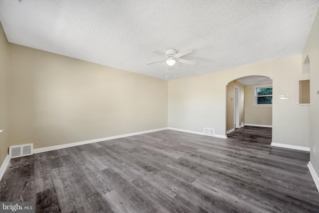 415 Arlington Ave, Upper Darby, PA 19082 - unfurnished room featuring ceiling fan, arched walkways, a textured ceiling, dark wood-type flooring, and baseboards