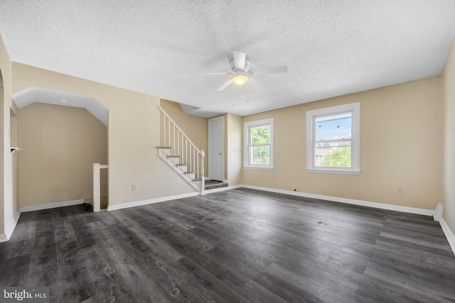 415 Arlington Ave, Upper Darby, PA 19082 - unfurnished living room with a textured ceiling, a ceiling fan, stairway, dark wood-style floors, and baseboards