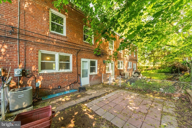 415 Arlington Ave, Upper Darby, PA 19082 - back of property with brick siding, fence, central air condition unit, and a patio area