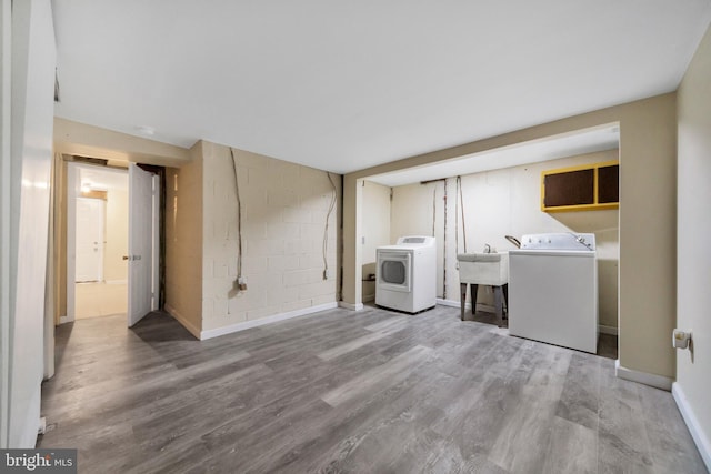 415 Arlington Ave, Upper Darby, PA 19082 - clothes washing area with independent washer and dryer, wood finished floors, baseboards, and concrete block wall