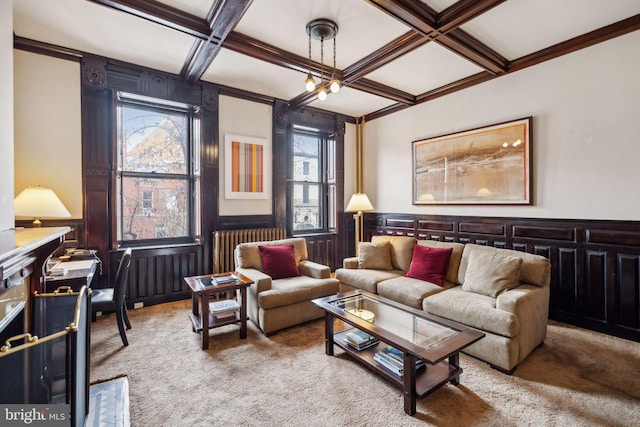 carpeted living room with coffered ceiling, beamed ceiling, a wainscoted wall, radiator heating unit, and crown molding