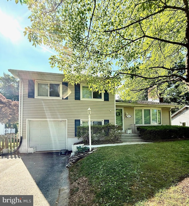 13 Wainwright Dr, Annapolis, MD 21401 - split level home featuring an attached garage, asphalt driveway, and a front yard
