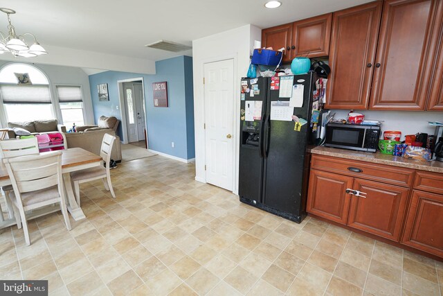 9557 Old Railroad Rd, Mardela Springs, MD 21837 - kitchen featuring black fridge, a chandelier, recessed lighting, open floor plan, and brown cabinets