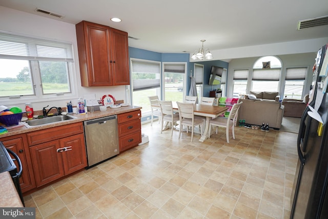 9557 Old Railroad Rd, Mardela Springs, MD 21837 - kitchen featuring dishwasher, a chandelier, a sink, light countertops, and freestanding refrigerator