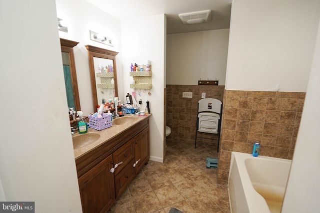 9557 Old Railroad Rd, Mardela Springs, MD 21837 - bathroom featuring tile walls, a garden tub, tile patterned floors, double vanity, and toilet