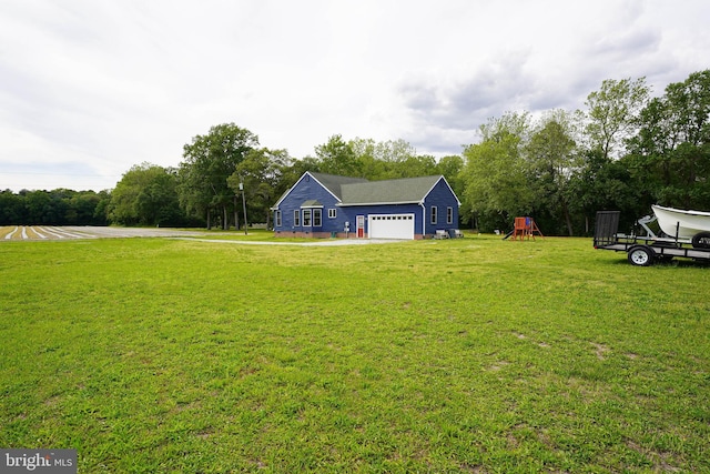 9557 Old Railroad Rd, Mardela Springs, MD 21837 - view of green lawn with a playground, an attached garage, and view of scattered trees