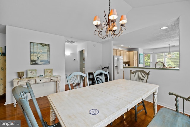 dining area with a chandelier, wood finished floors, baseboards, and recessed lighting