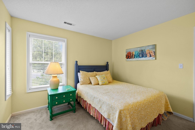 carpeted bedroom featuring baseboards