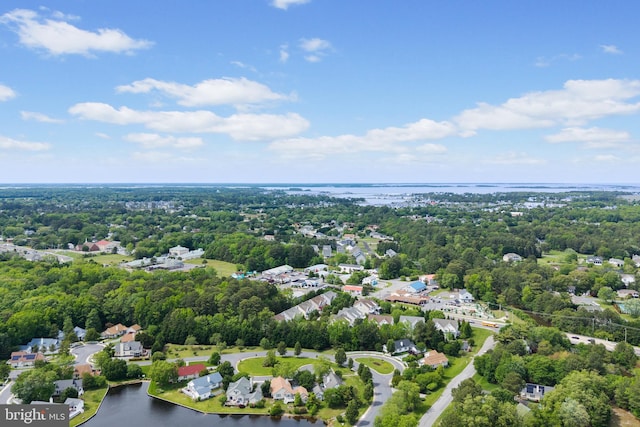 drone / aerial view of a large body of water and a tree filled landscape