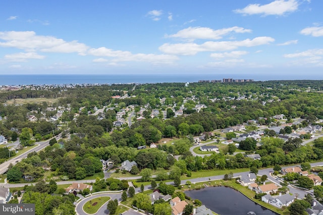 drone / aerial view of a large body of water and a tree filled landscape