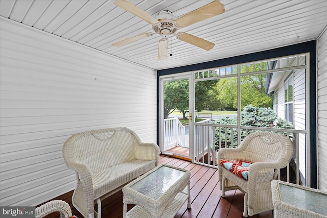 sunroom / solarium with a ceiling fan