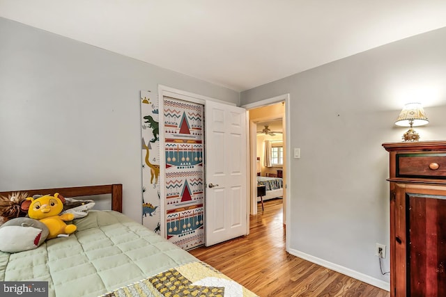 bedroom featuring light wood-type flooring and baseboards