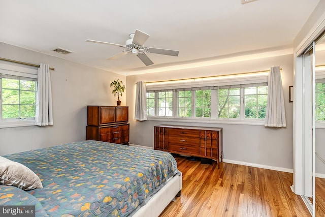 bedroom with wood finished floors, baseboards, and ceiling fan