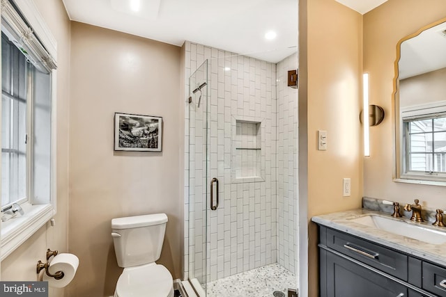full bath featuring a shower stall, toilet, vanity, and recessed lighting