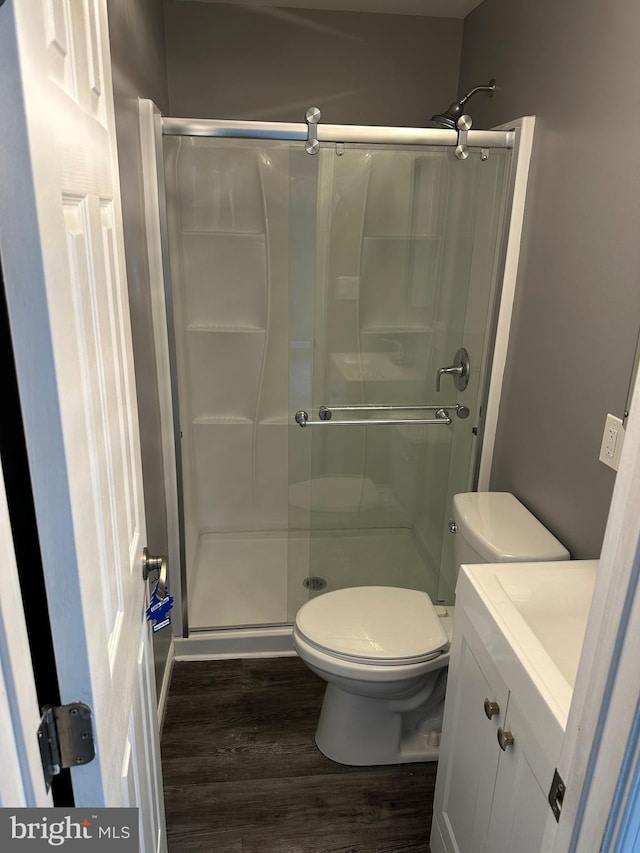 7235 Baltimore Annapolis Blvd, Glen Burnie, MD 21061 - full bath featuring wood finished floors, toilet, a stall shower, and vanity