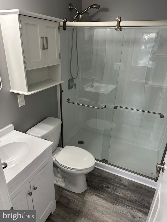 7235 Baltimore Annapolis Blvd, Glen Burnie, MD 21061 - full bath featuring wood finished floors, a shower stall, toilet, and vanity