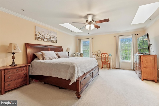 bedroom featuring a skylight, crown molding, light carpet, and multiple windows