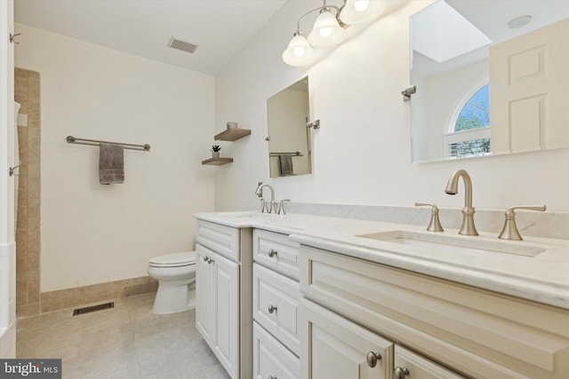 full bath featuring tile patterned floors, toilet, double vanity, and tiled shower