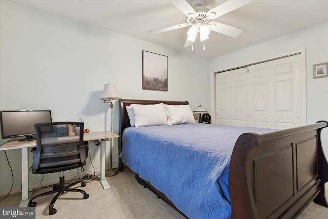 bedroom with light colored carpet, a closet, an office area, and a ceiling fan