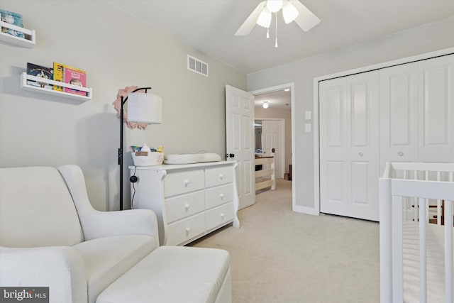bedroom with light carpet, a closet, and ceiling fan