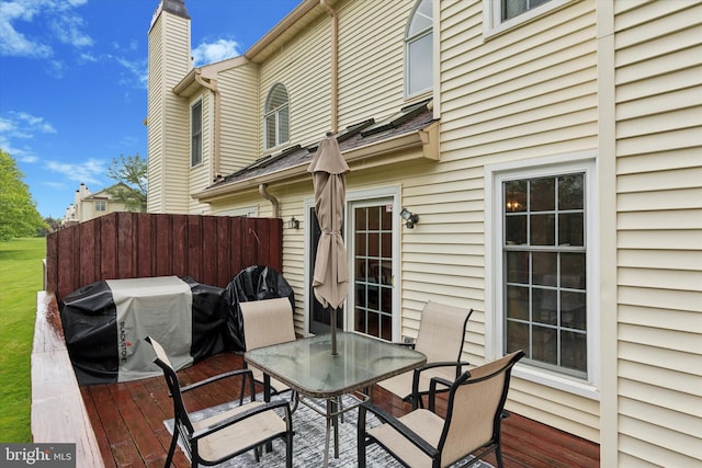deck with fence, area for grilling, and outdoor dining area