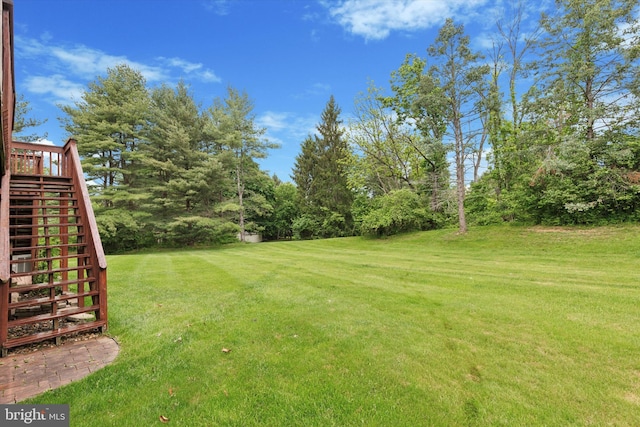 view of green lawn with stairway