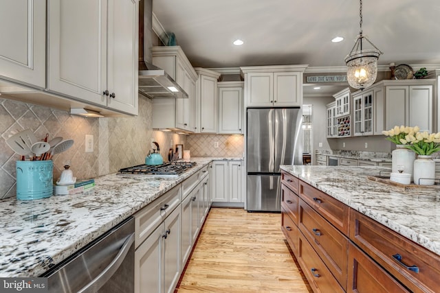 6034 Franconia Rd, Alexandria, VA 22310 - kitchen with stainless steel appliances, light wood-style flooring, glass insert cabinets, recessed lighting, and light stone counters