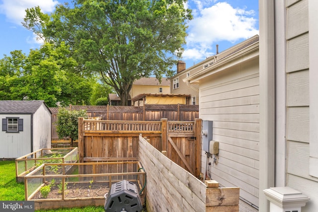 6034 Franconia Rd, Alexandria, VA 22310 - wooden deck with a fenced backyard, a vegetable garden, and a gate