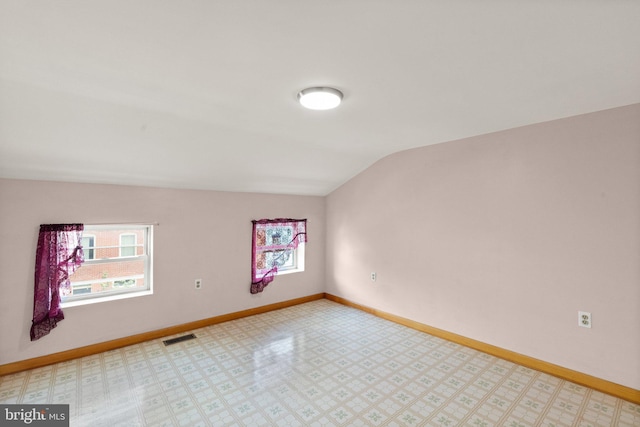 312 S Wolfe St, Baltimore, MD 21231 - unfurnished room featuring lofted ceiling, baseboards, and light floors