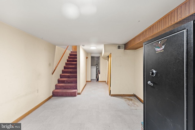 312 S Wolfe St, Baltimore, MD 21231 - finished basement with baseboards, stairs, washer / dryer, and light flooring