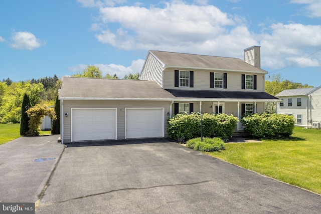 503 Forest Ave, Bellefonte, PA 16823 - view of front of home featuring an attached garage, asphalt driveway, a chimney, and a front yard