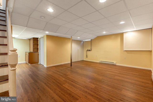 503 Forest Ave, Bellefonte, PA 16823 - finished basement with a baseboard heating unit, wood finished floors, stairs, baseboards, and recessed lighting