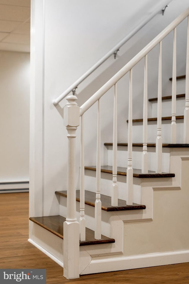 503 Forest Ave, Bellefonte, PA 16823 - stairway with wood finished floors, baseboards, and a baseboard heating unit