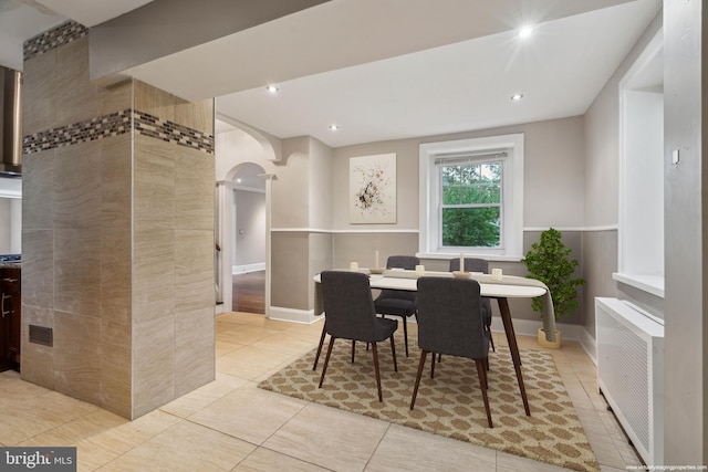 2424 Golf Rd, Philadelphia, PA 19131 - dining space with arched walkways, light tile patterned floors, radiator heating unit, recessed lighting, and baseboards