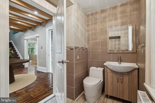 2424 Golf Rd, Philadelphia, PA 19131 - bathroom with vanity, tile walls, radiator heating unit, toilet, and beamed ceiling