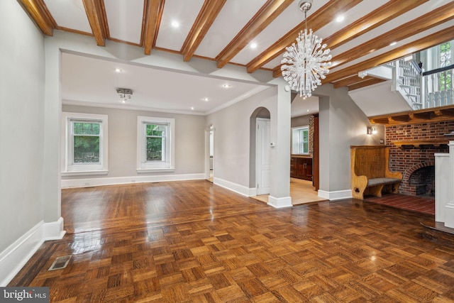 2424 Golf Rd, Philadelphia, PA 19131 - unfurnished living room featuring arched walkways, baseboards, crown molding, a brick fireplace, and a chandelier