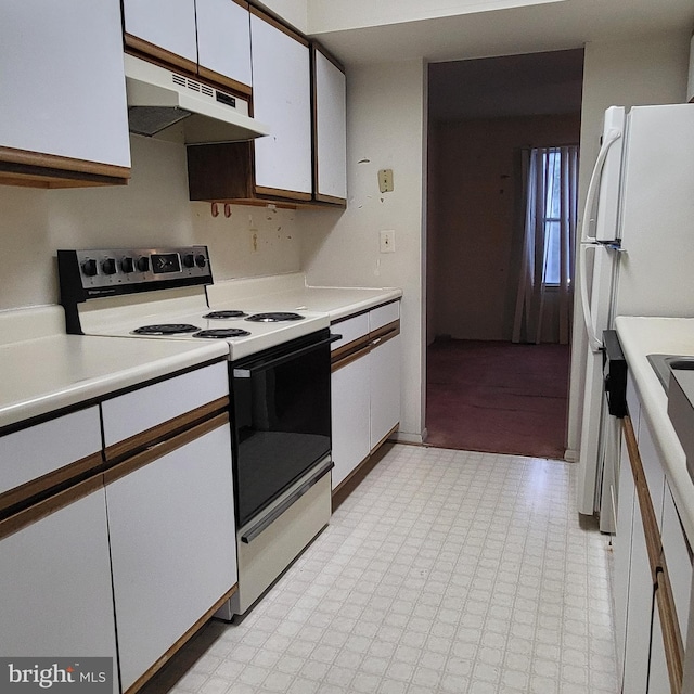 kitchen with electric range oven, under cabinet range hood, white cabinets, and light countertops