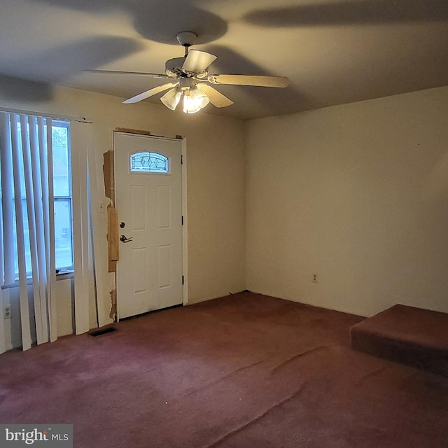 carpeted foyer featuring a ceiling fan