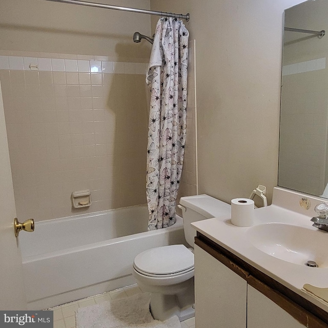 full bathroom with shower / tub combo with curtain, toilet, tile patterned floors, and vanity