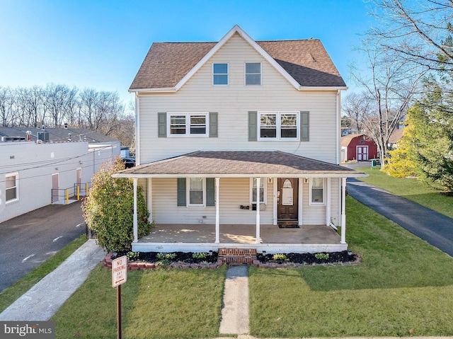 view of front facade featuring covered porch and a front yard