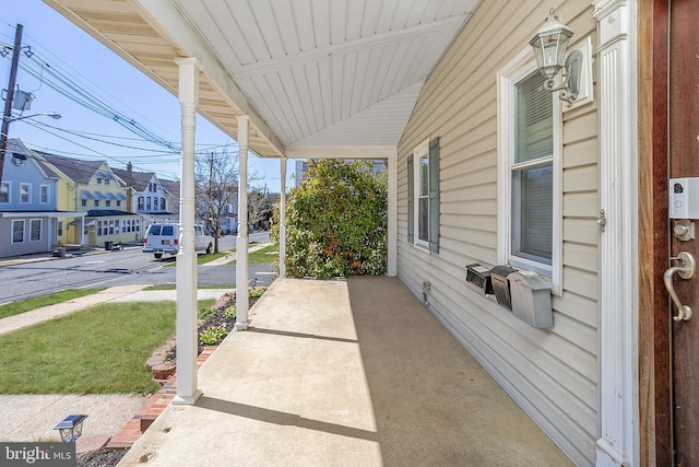 view of patio featuring covered porch and a residential view